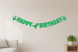 'Happy Birthday' banner with dinosaur silhouette spaces