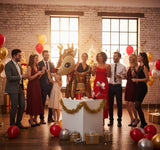 Group of people celebrating a birthday with a decorated cake and balloons in a festive room.