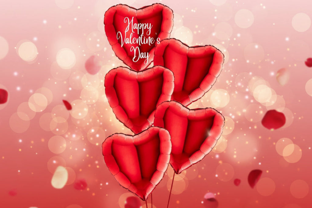 Red heart-shaped balloons with 'Happy Valentine's Day' on